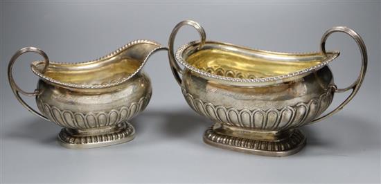 A George III demi fluted silver three piece tea set, by Emes & Barnard, London, 1811, with engraved inscription, gross 38oz.